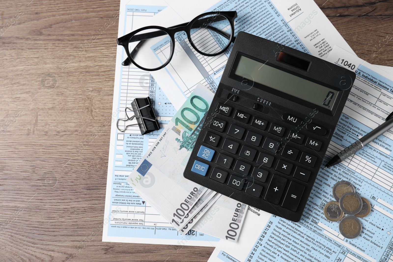 Photo of Tax accounting. Flat lay composition with calculator and documents on wooden table, space for text