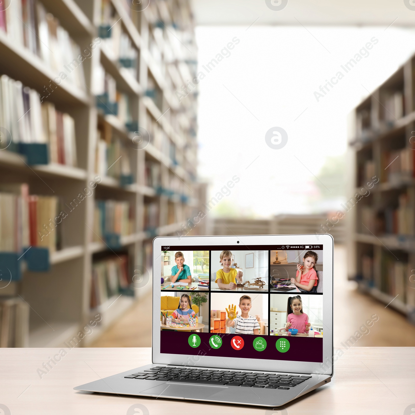 Image of Distance education during quarantine and lockdown due to Covid-19 pandemic. Modern laptop with online classroom on screen in library