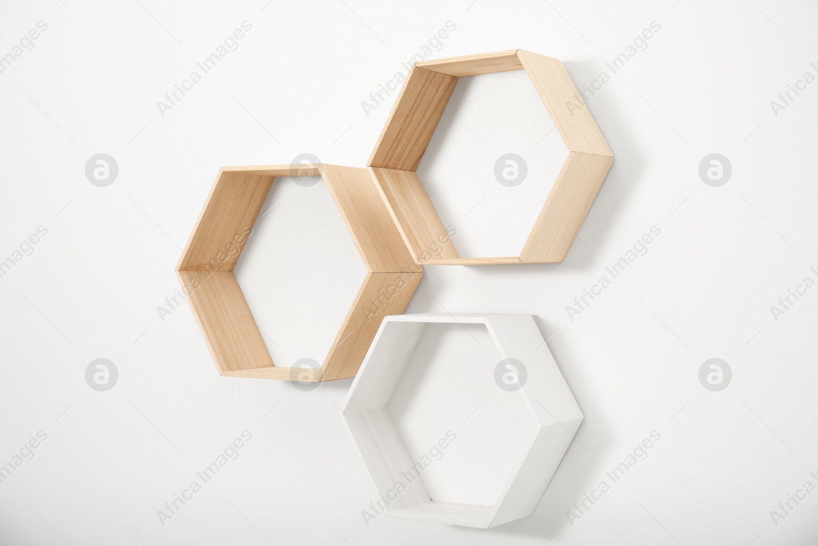 Photo of Empty honeycomb shaped shelves on white wall