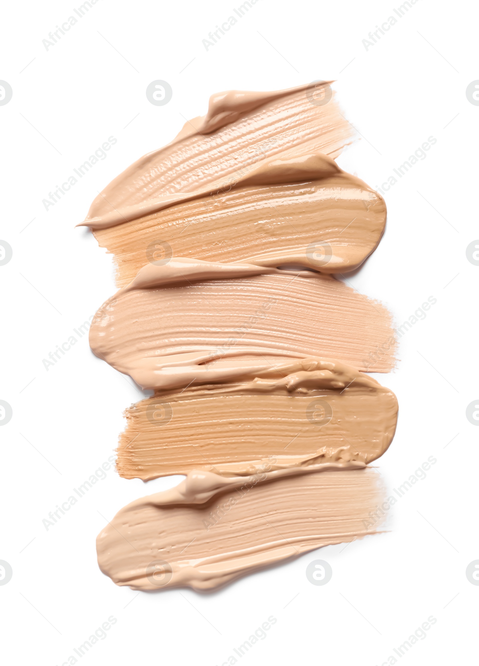 Photo of Samples of skin foundation on white background, top view