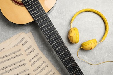 Composition with guitar and music notations on light table, flat lay