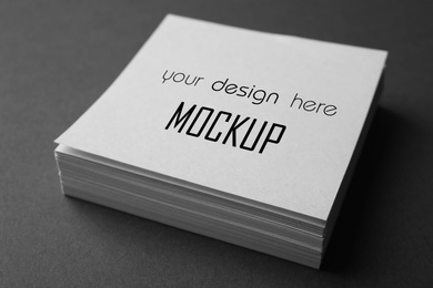 Stack of note papers with text Mockup Your Design Here on top