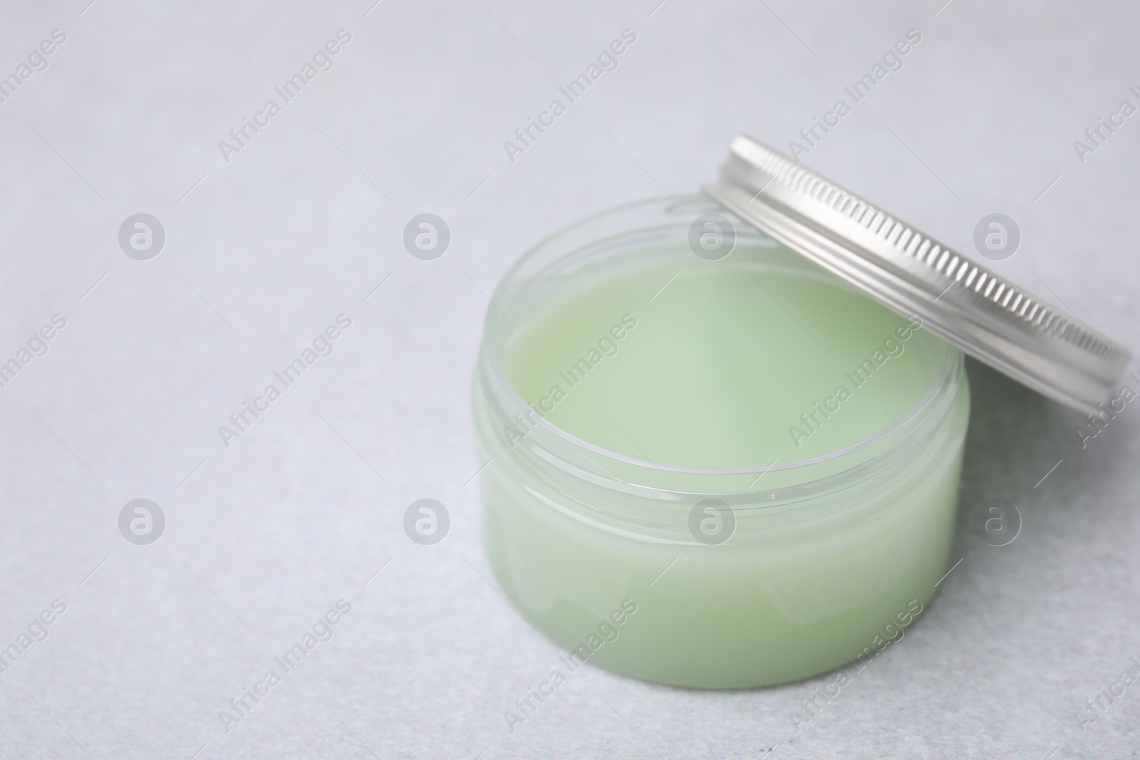 Photo of Jar of petroleum jelly on light gray background