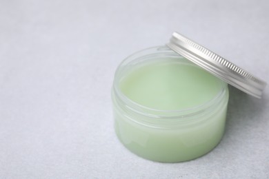 Photo of Jar of petroleum jelly on light gray background