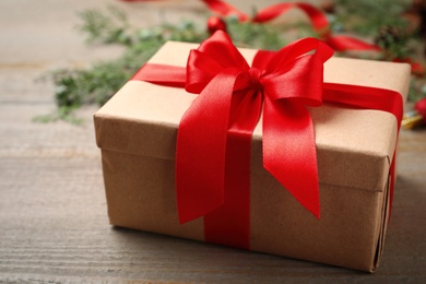 Photo of Christmas gift box on wooden background, closeup