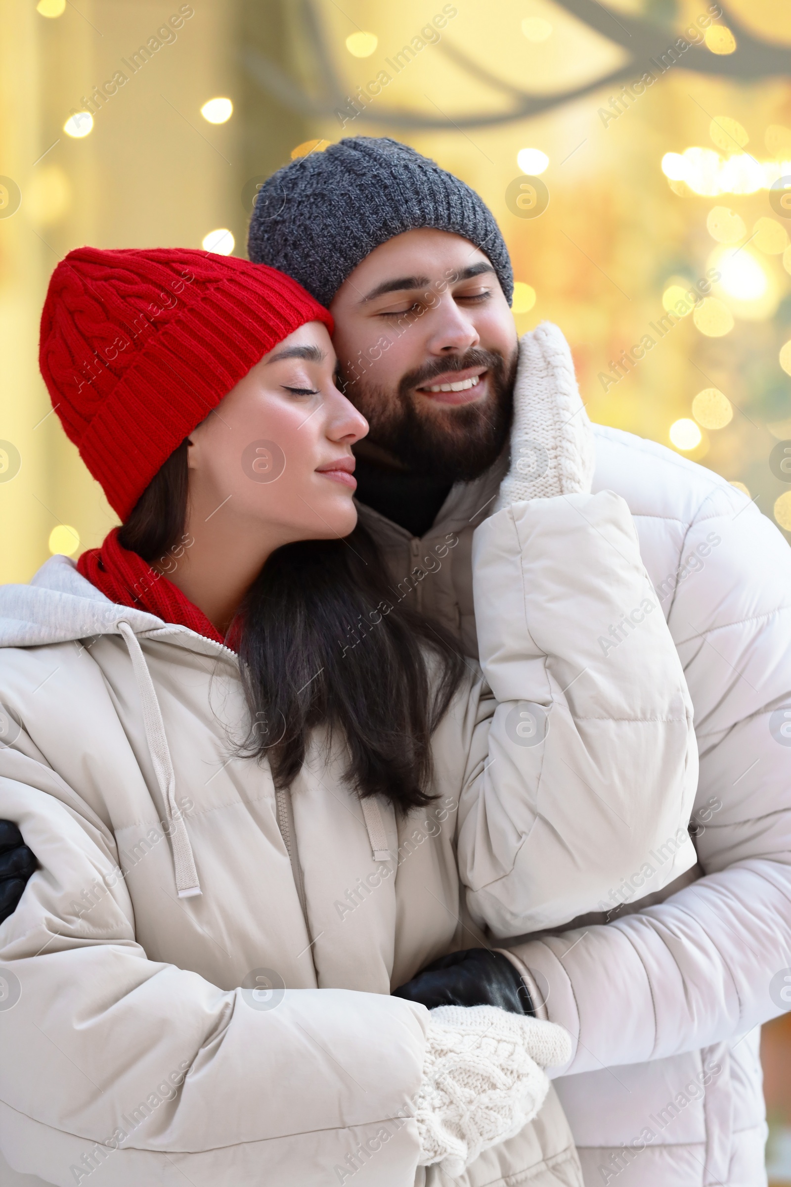 Photo of Portrait of lovely couple outdoors against blurred lights outdoors