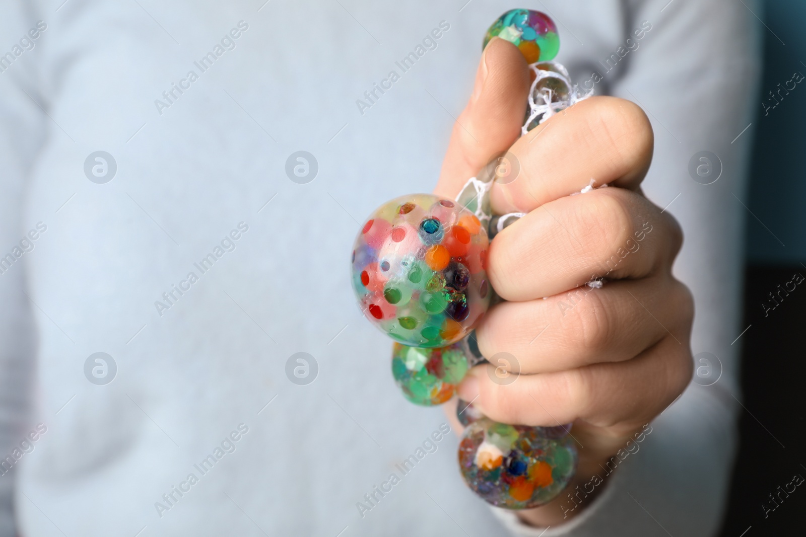 Photo of Woman squeezing colorful slime, closeup. Antistress toy