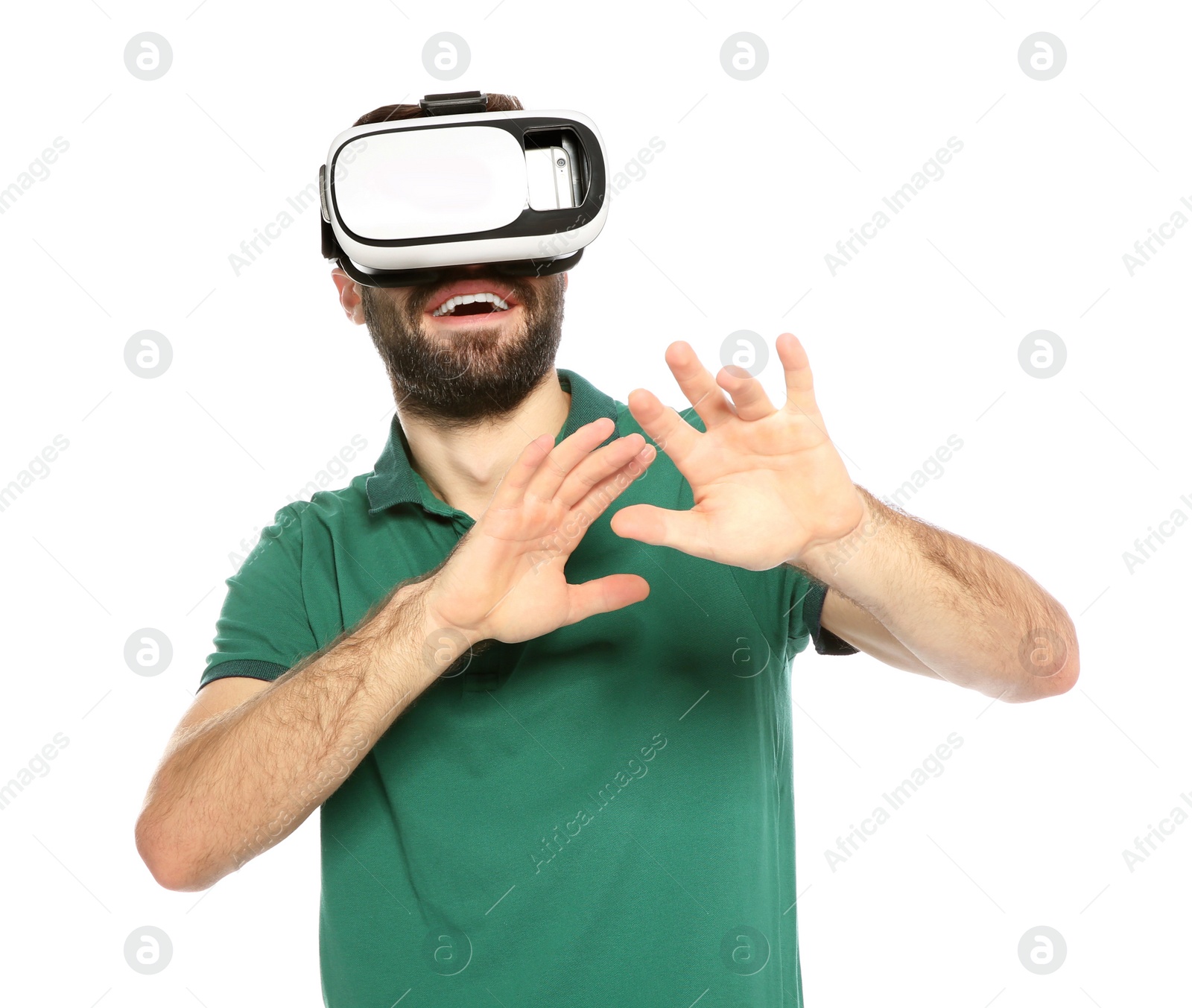 Photo of Emotional young man playing video games with virtual reality headset isolated on white