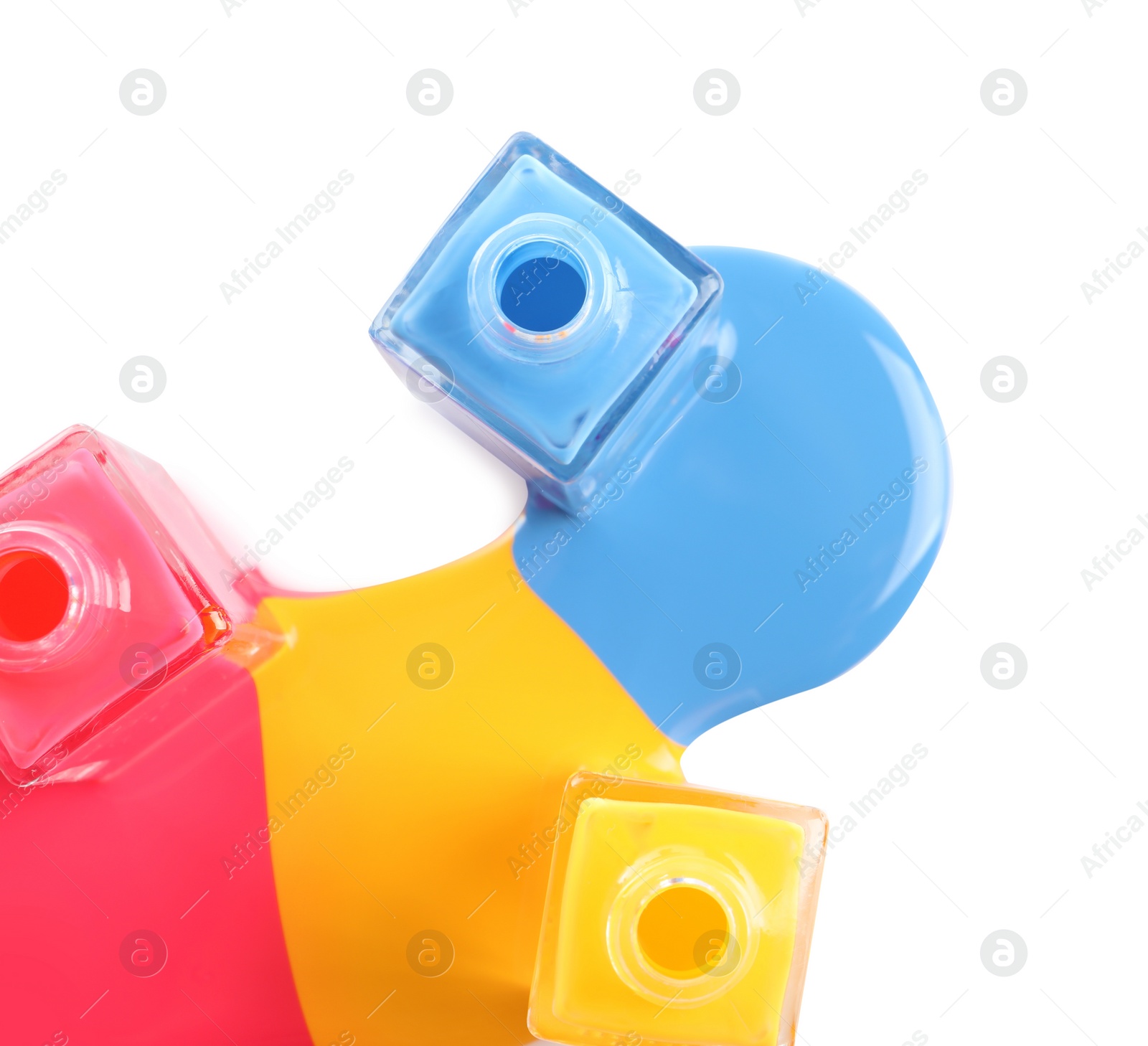 Photo of Spilled different nail polishes with bottles on white background, top view