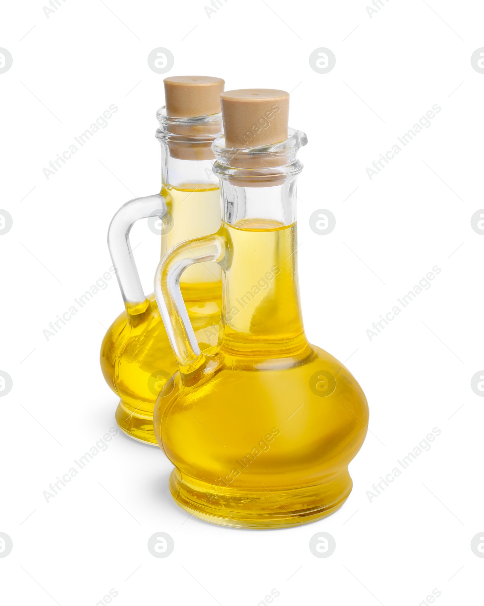 Photo of Glass jugs of cooking oil on white background