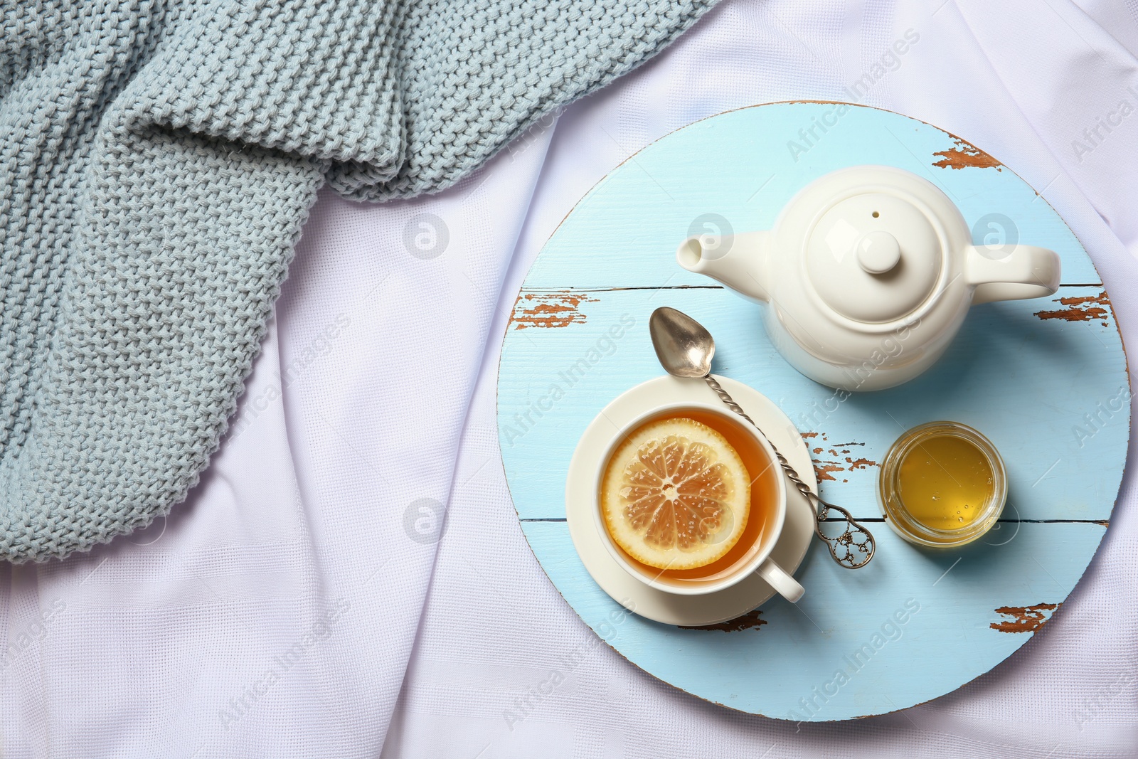 Photo of Flat lay composition with lemon tea and teapot on wooden board