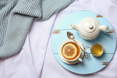 Photo of Flat lay composition with lemon tea and teapot on wooden board