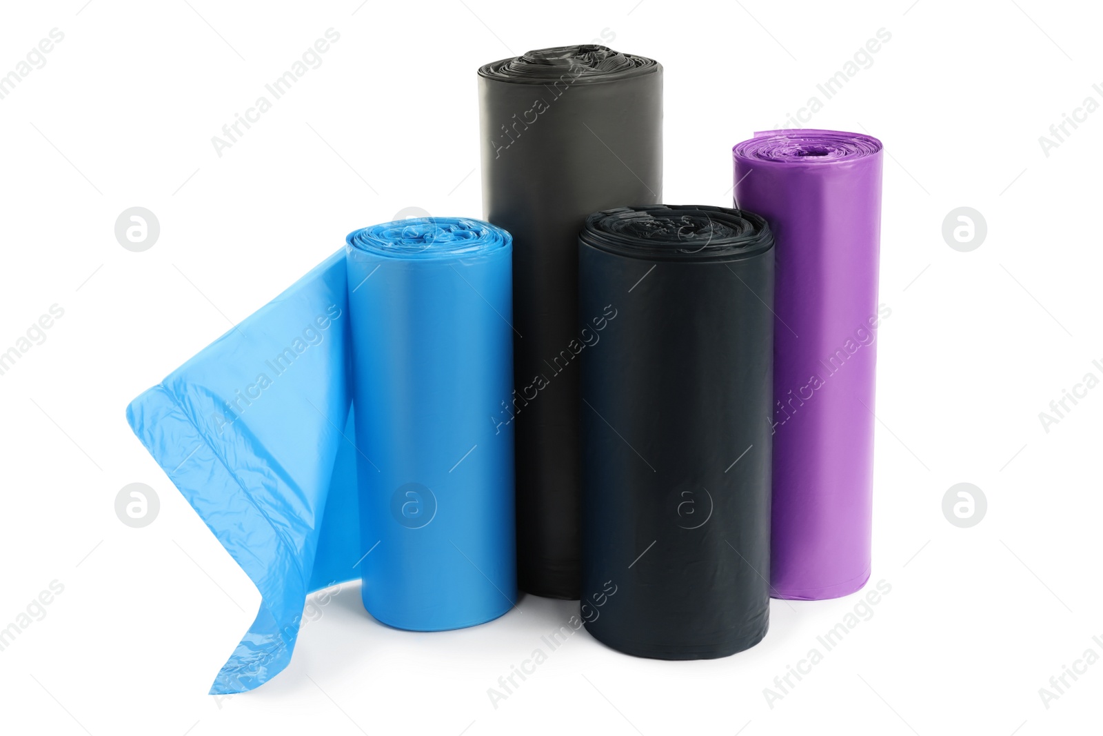 Photo of Rolls of different garbage bags on white background. Cleaning supplies