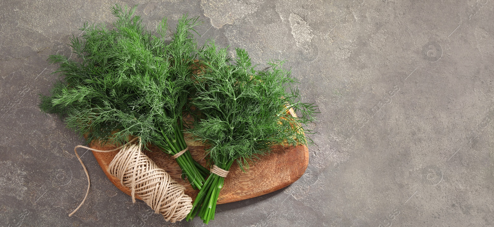 Image of Fresh dill and twine on grey table, top view. Banner design with space for text