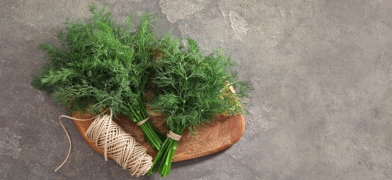 Image of Fresh dill and twine on grey table, top view. Banner design with space for text