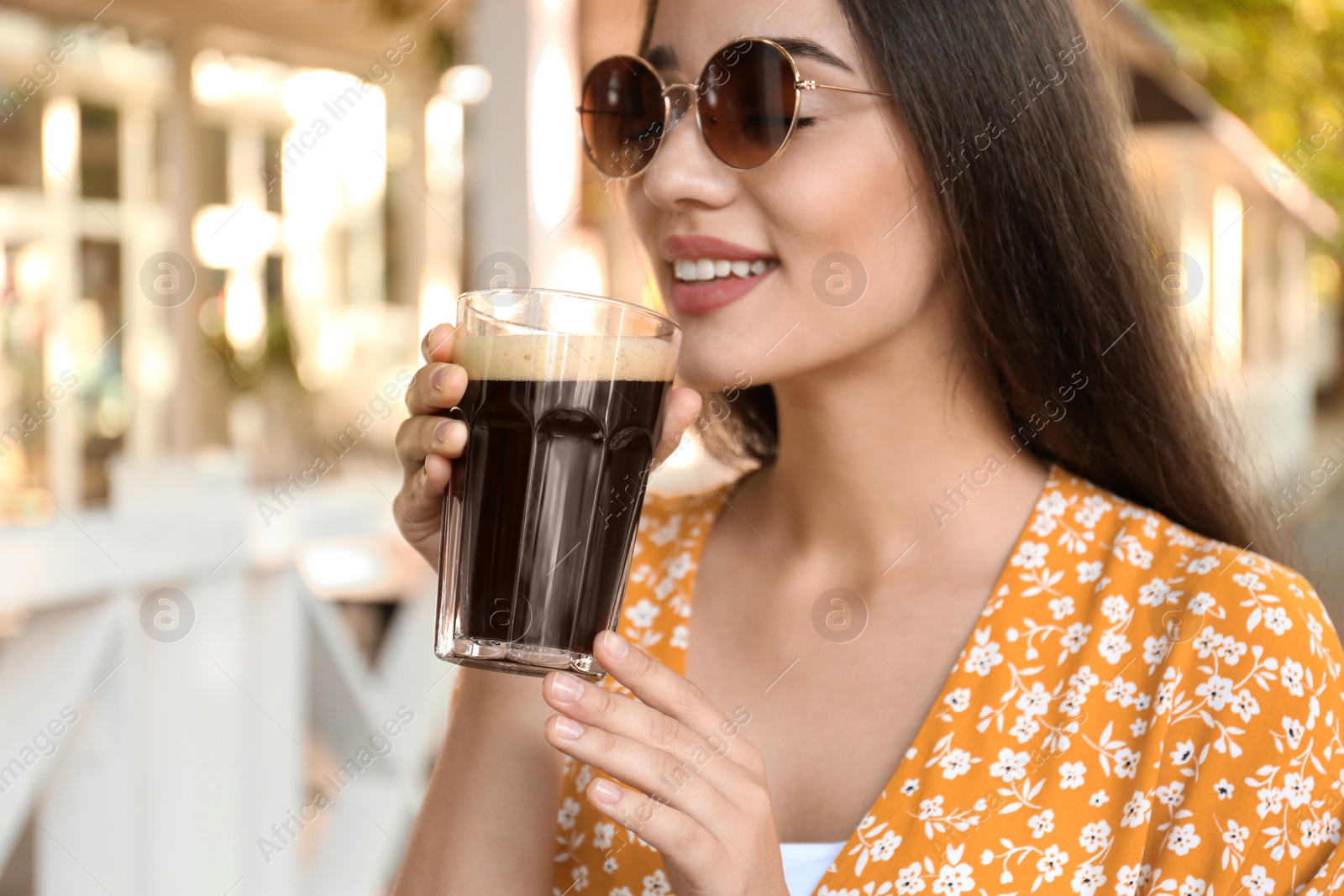 Photo of Beautiful woman with cold kvass outdoors. Traditional Russian summer drink