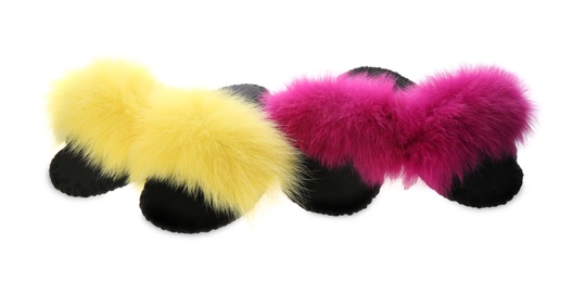 Photo of Soft open toe slippers with yellow and pink fur on white background