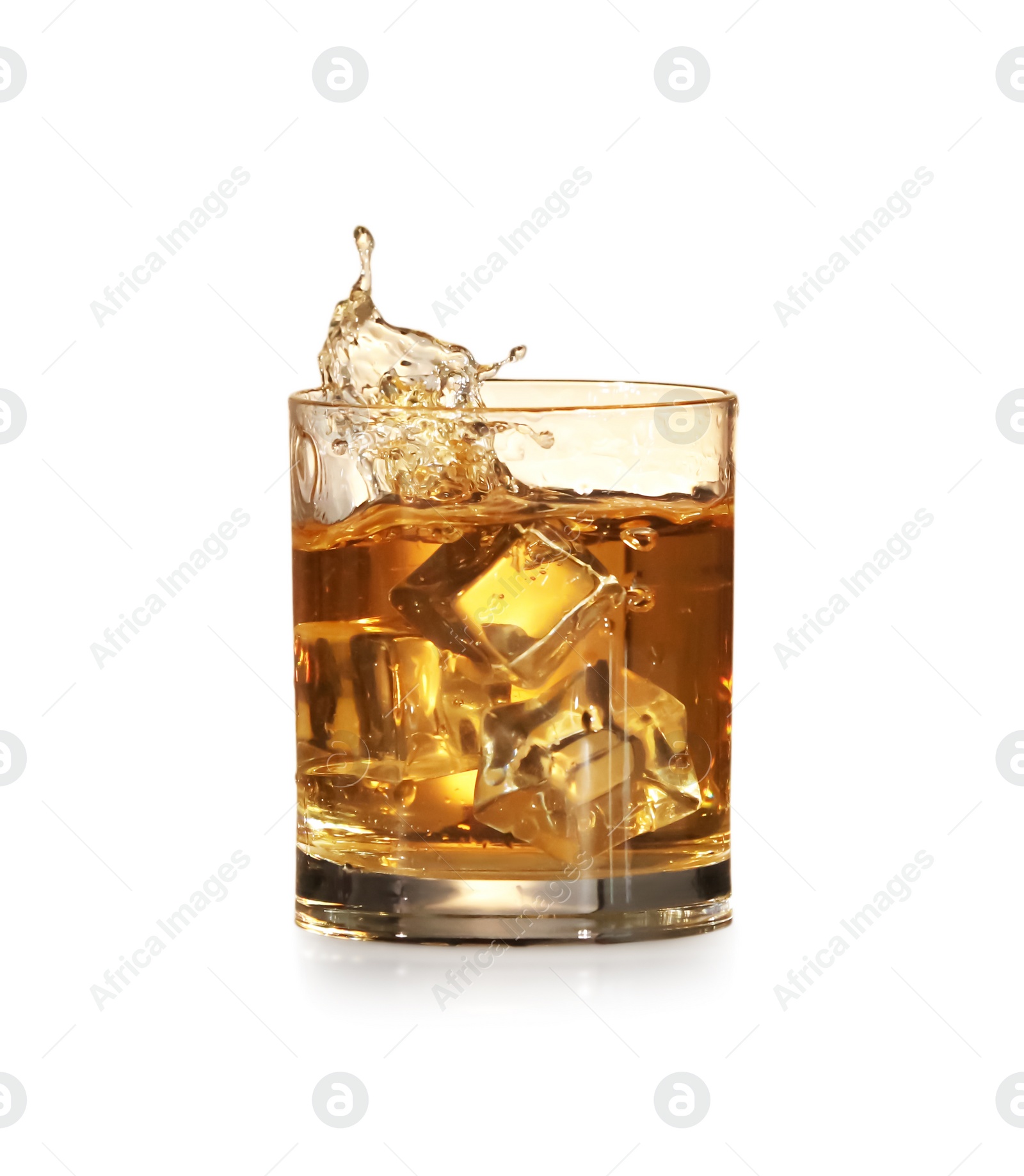 Photo of Whiskey splashing out of glass on white background