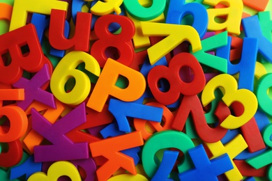 Photo of Plastic magnetic letters and numbers as background, top view