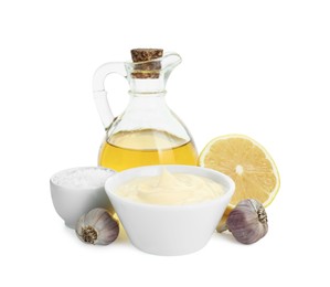 Photo of Fresh mayonnaise sauce in bowl and ingredients isolated on white