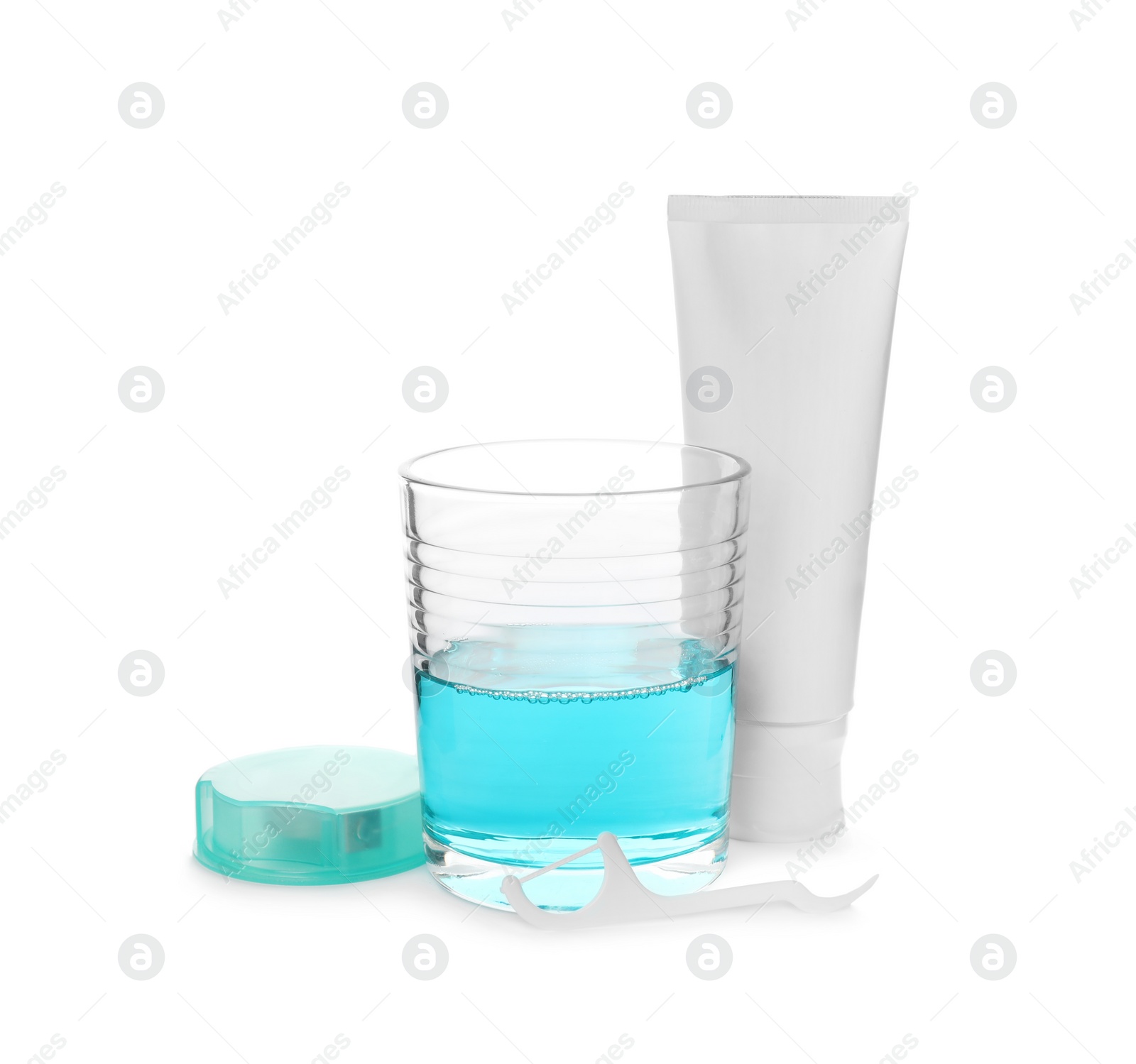 Photo of Mouthwash, dental floss and toothpaste on white background