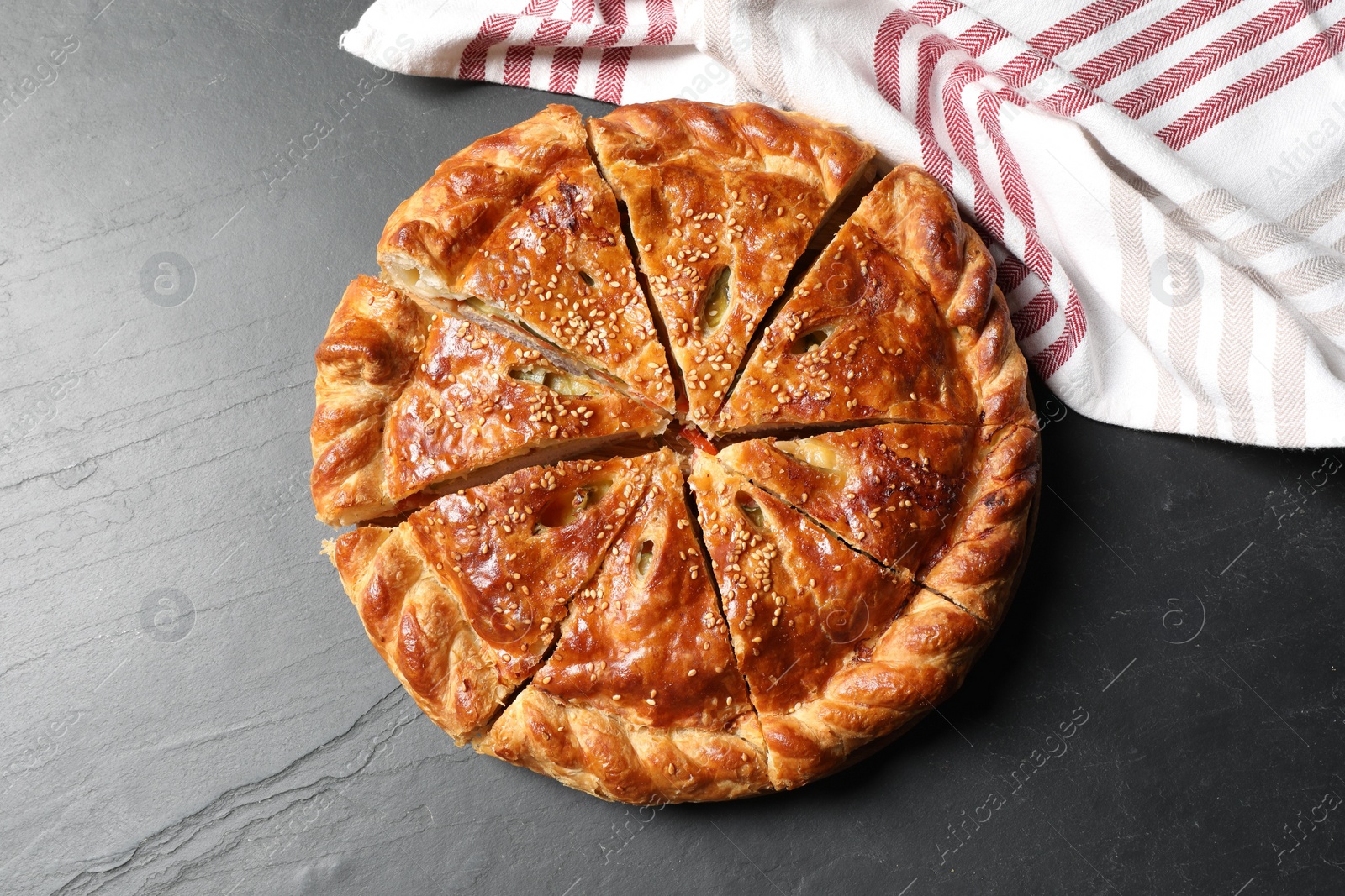 Photo of Cut delicious homemade pie on black table, top view