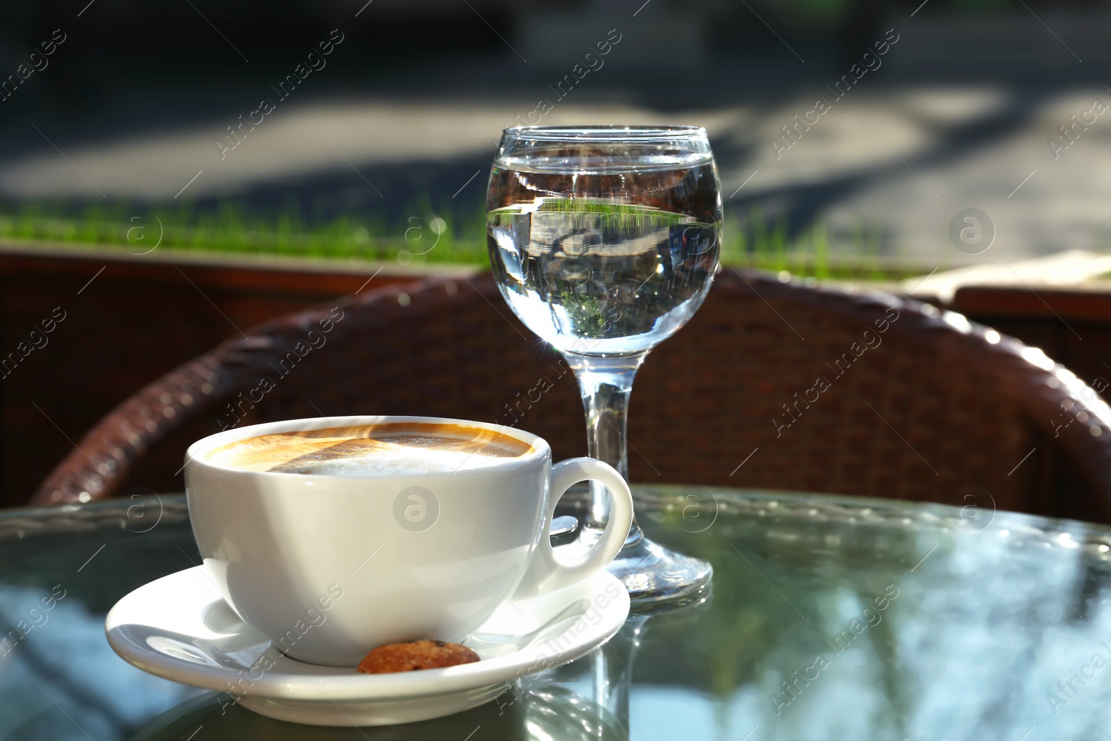 Photo of Cup of fresh aromatic coffee at table in cafe