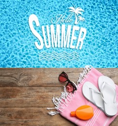 Image of Hello Summer. Beach accessories on wooden deck near swimming pool, flat lay