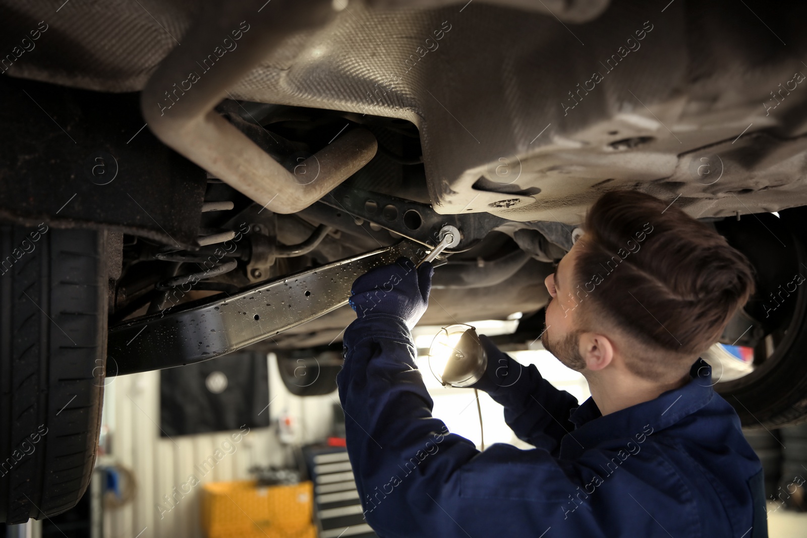 Photo of Technician checking modern car at automobile repair shop