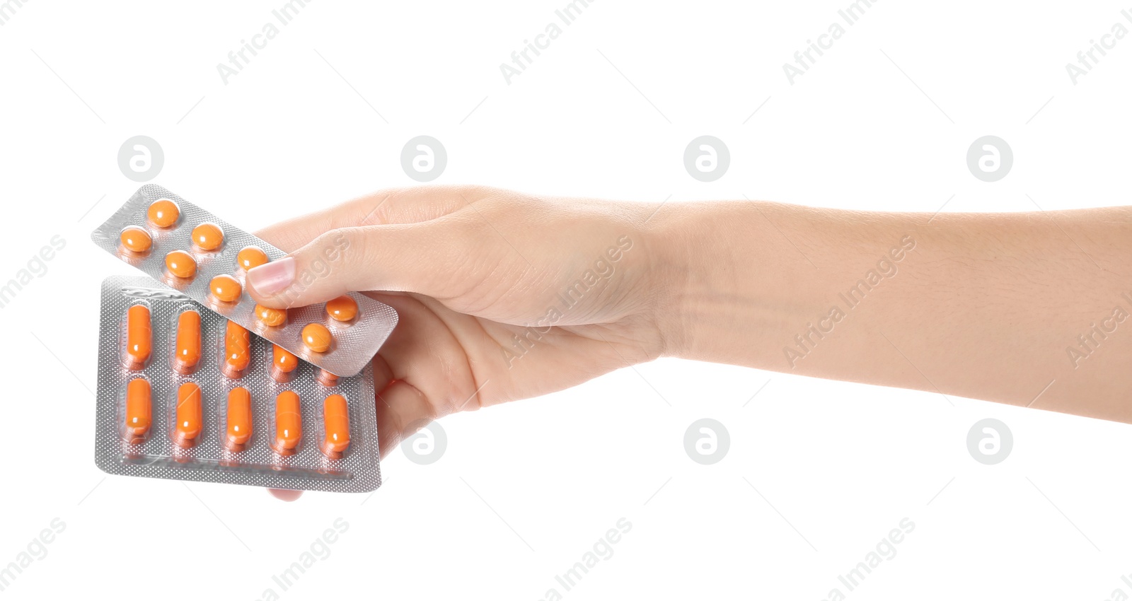 Photo of Woman holding pills in blister packs on white background, closeup