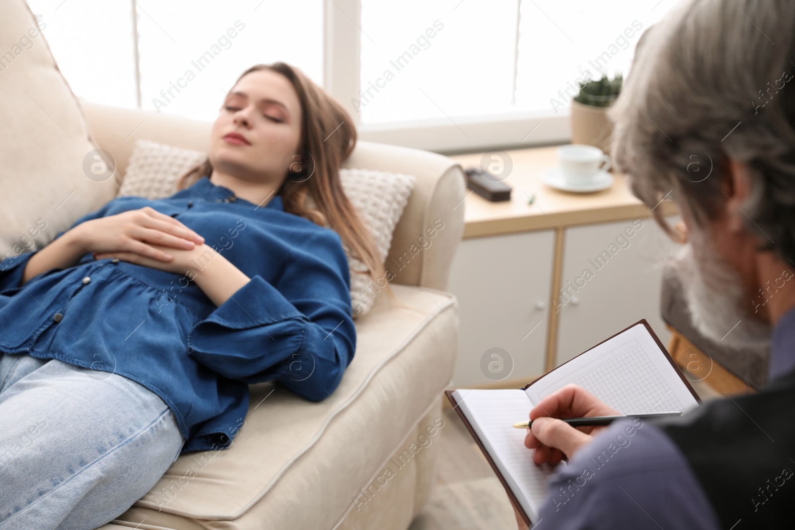 Photo of Psychotherapist and patient in office. Hypnotherapy session