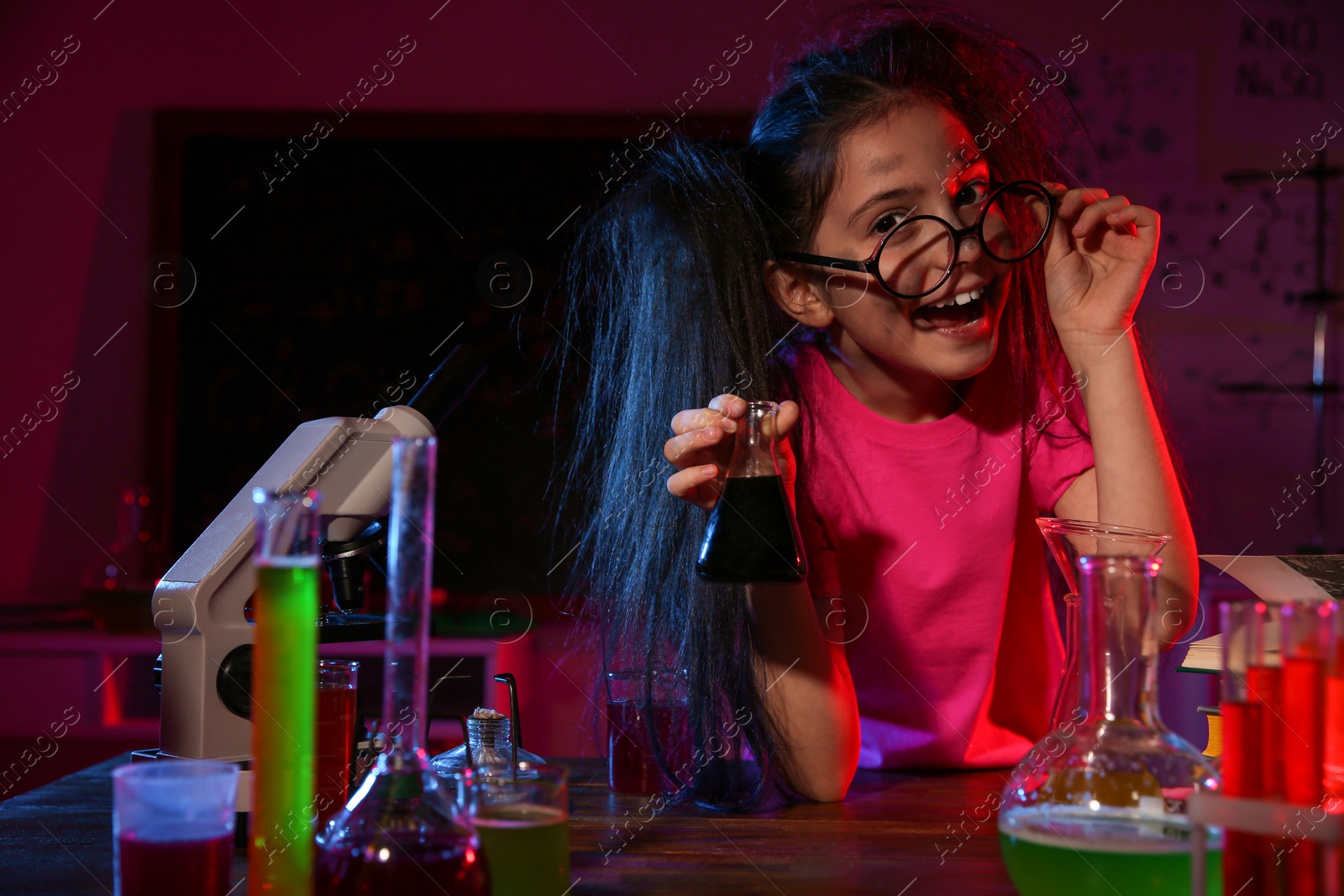 Photo of Child doing chemical research in laboratory. Dangerous experiment