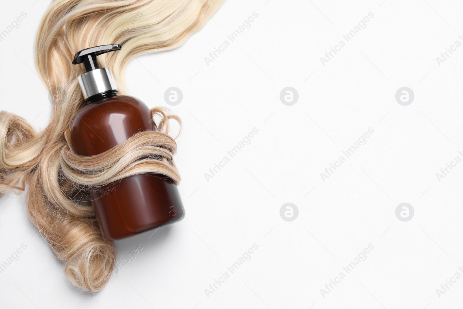 Photo of Lock of beautiful blonde curly hair and cosmetic product on white background, top view