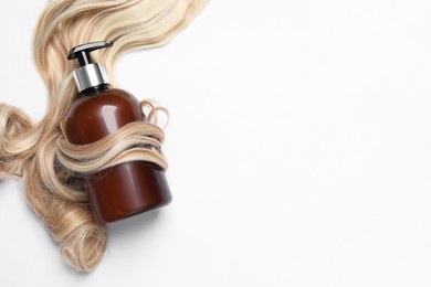 Photo of Lock of beautiful blonde curly hair and cosmetic product on white background, top view
