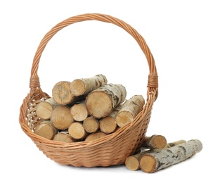 Wicker basket with firewood on white background