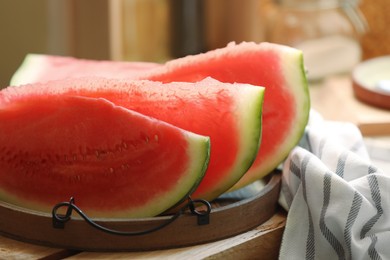 Photo of Slices of fresh juicy watermelon on wooden table, closeup