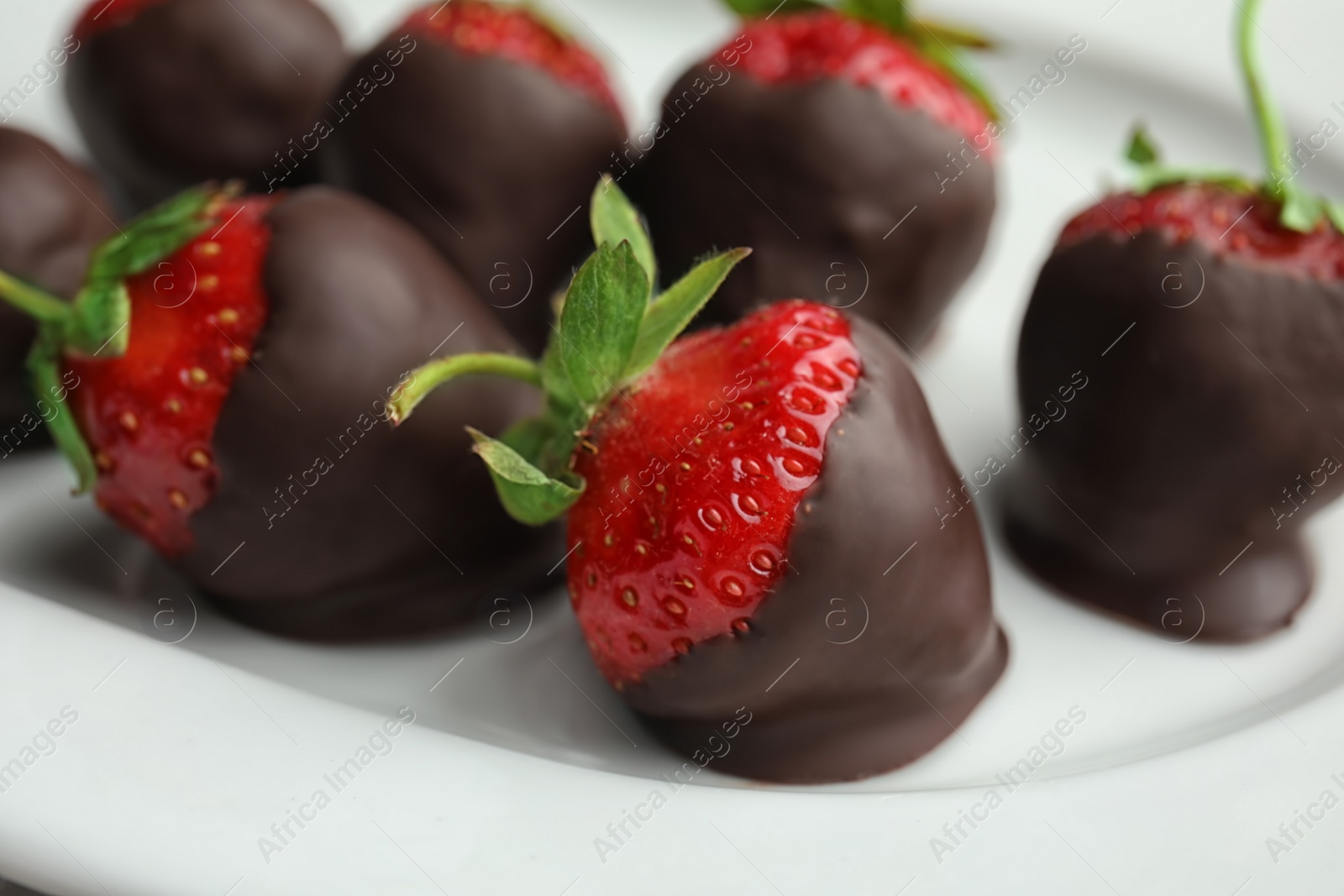 Photo of Plate with delicious chocolate covered strawberries, closeup