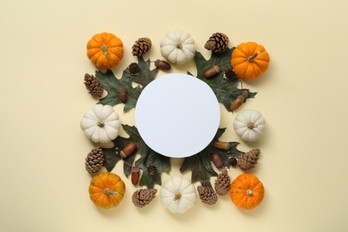Thanksgiving day. Flat lay composition with pumpkins and blank card on beige background, space for text