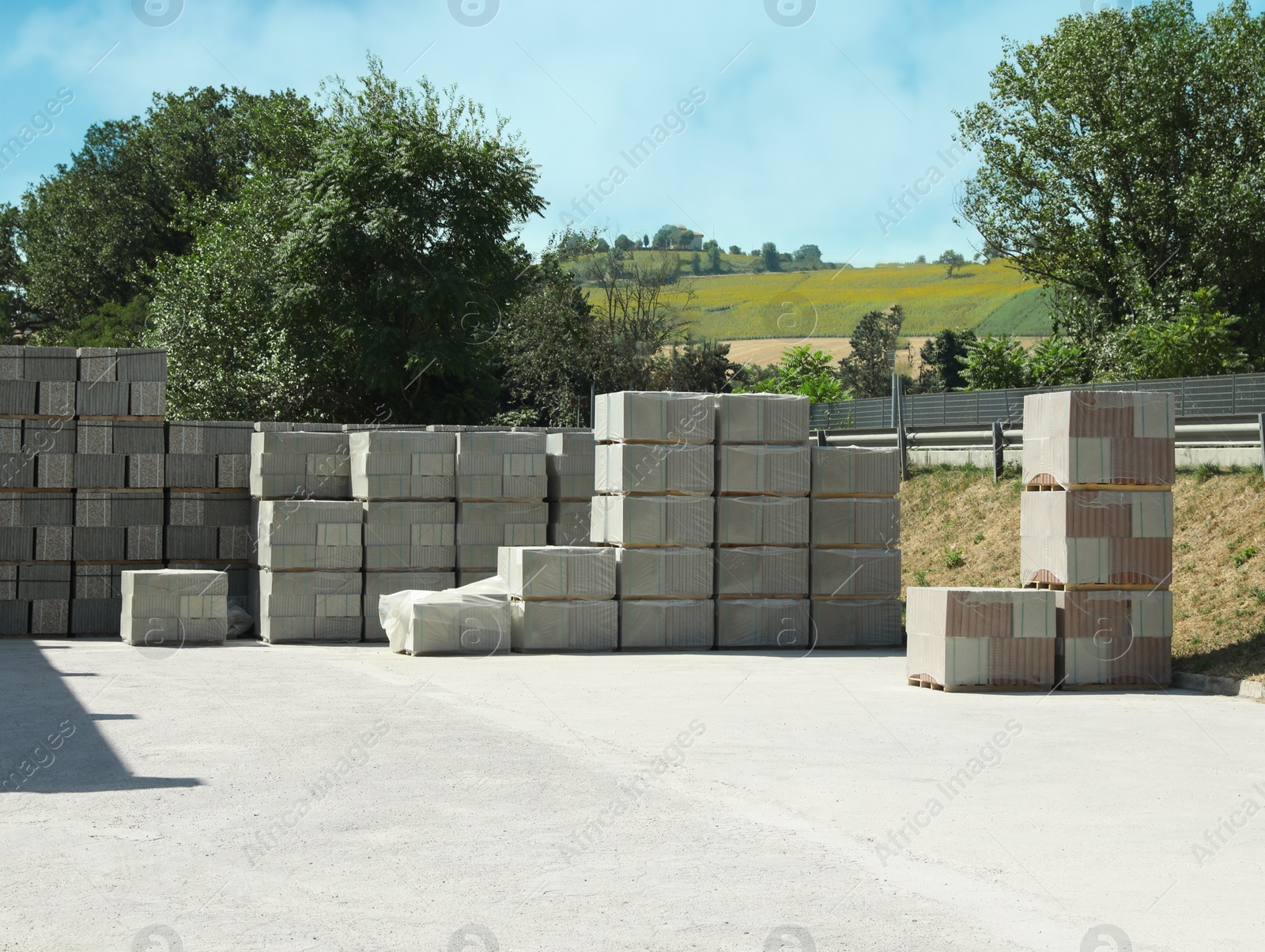 Photo of Packages of sidewalk tile outdoors on sunny day