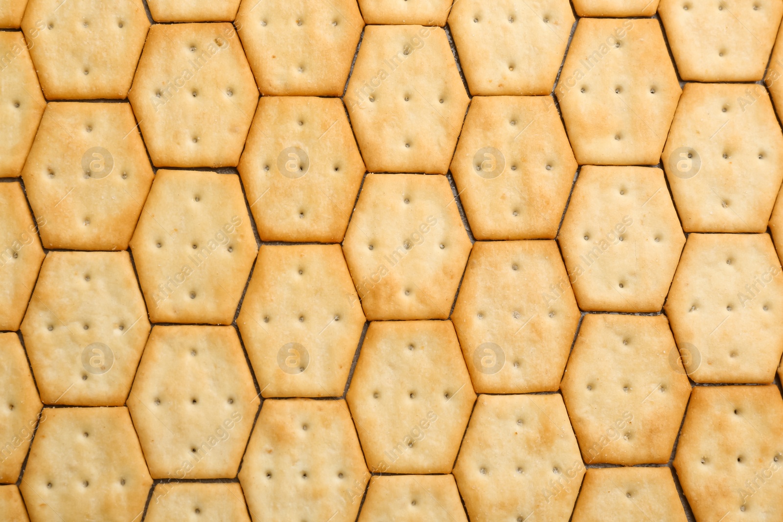 Photo of Many delicious crackers as background, top view