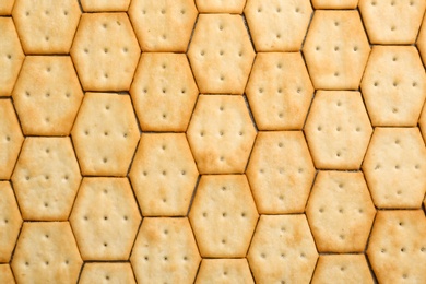 Photo of Many delicious crackers as background, top view
