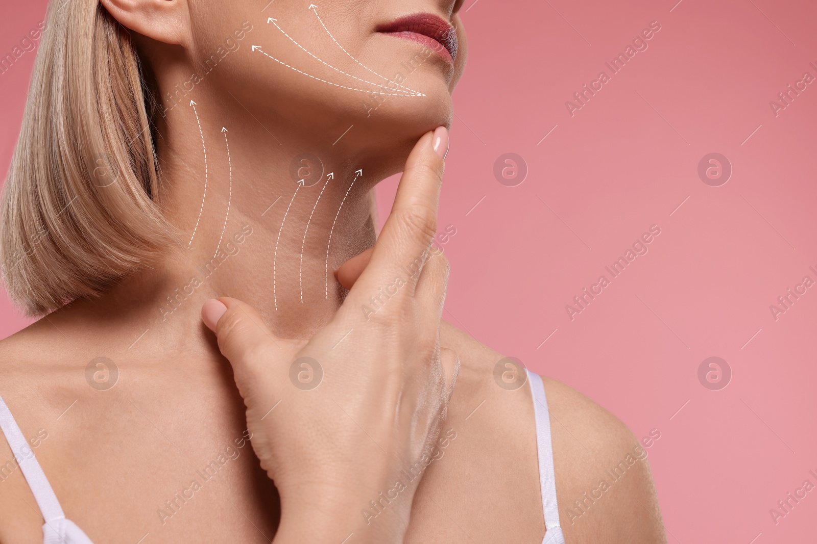 Image of Woman with perfect skin after cosmetic treatment on pink background, space for text. Lifting arrows on her neck and face