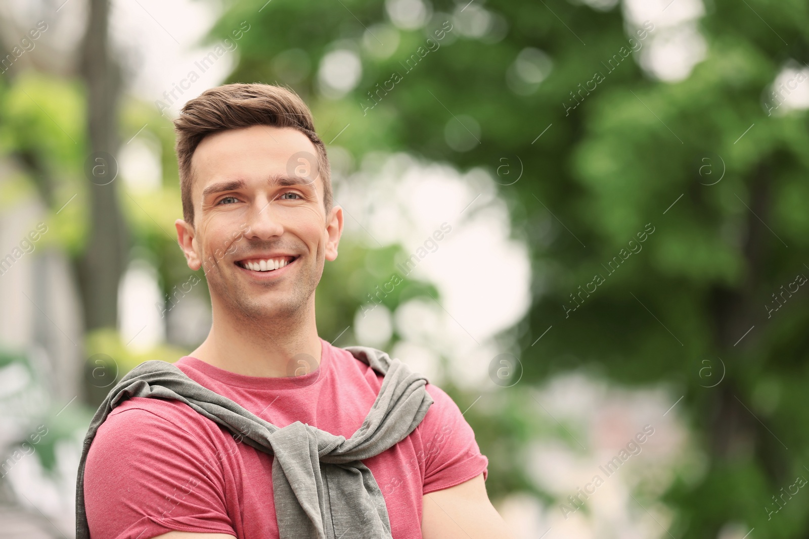 Photo of Portrait of attractive young man in stylish outfit outdoors