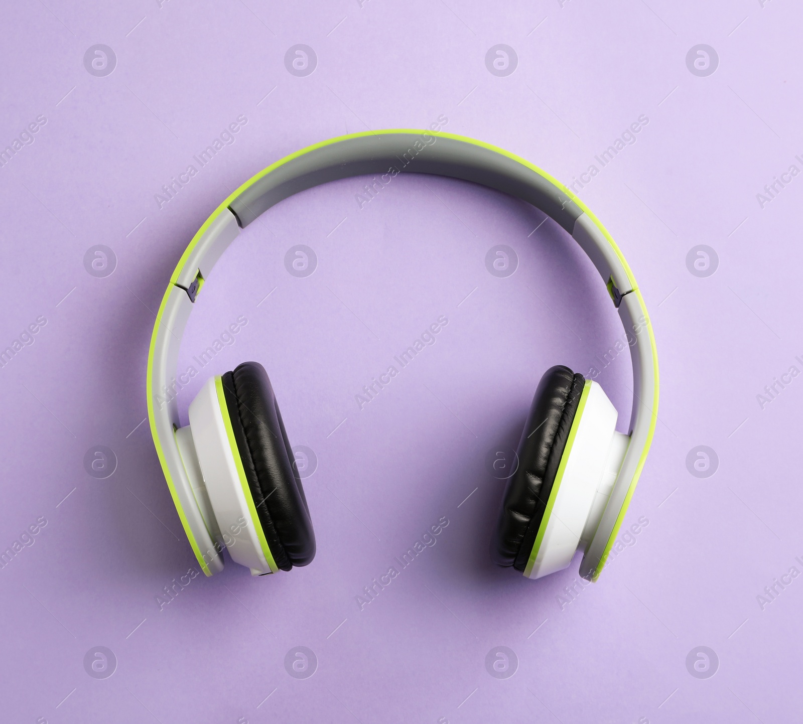 Photo of Wireless headphones on color background, top view