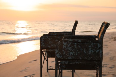 Photo of Camping chairs on sandy beach near sea