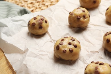 Uncooked chocolate chip cookies on table, closeup