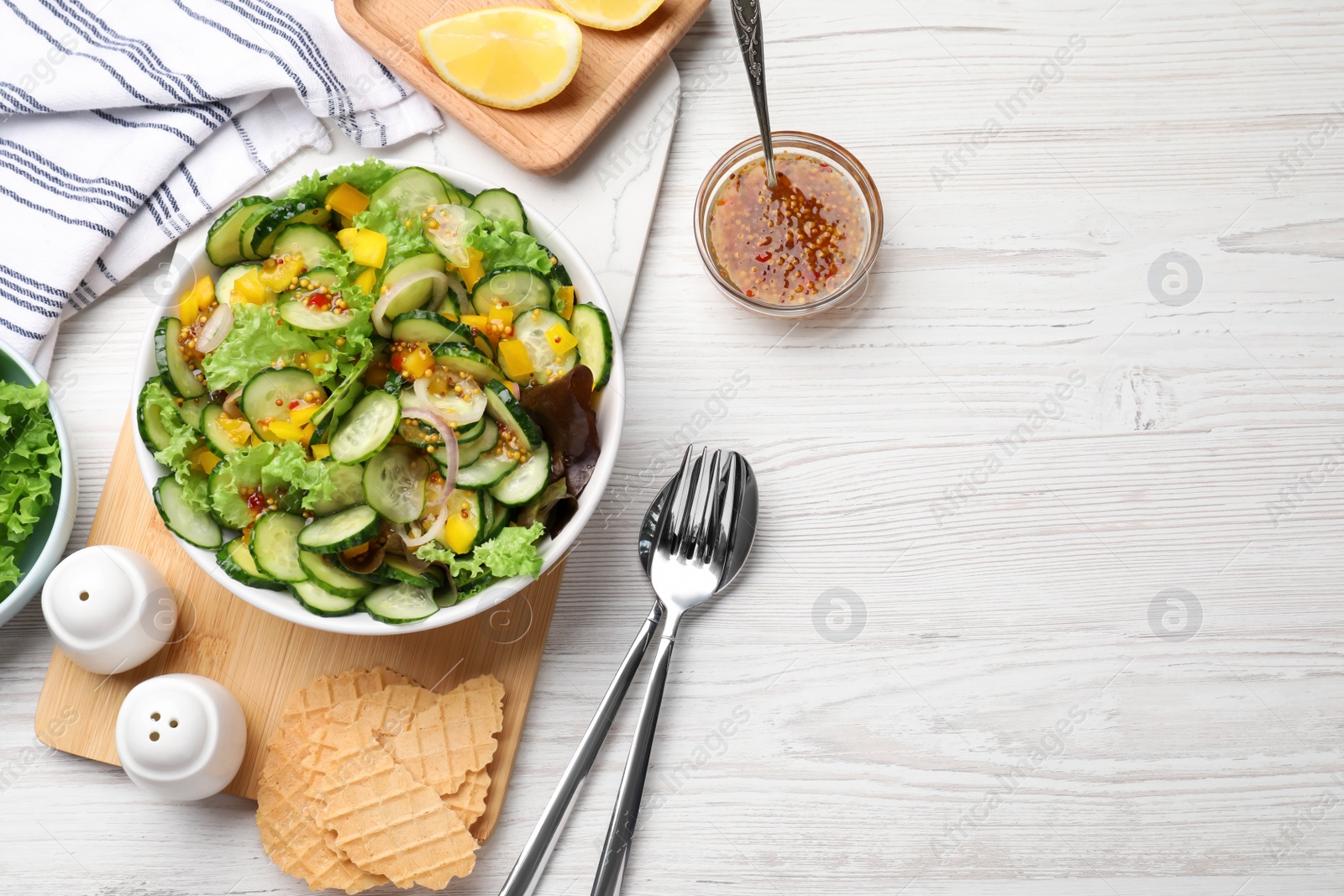 Photo of Flat lay composition with delicious cucumber salad on white wooden table. Space for text