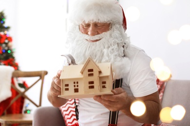 Photo of Authentic Santa Claus making toy in workshop