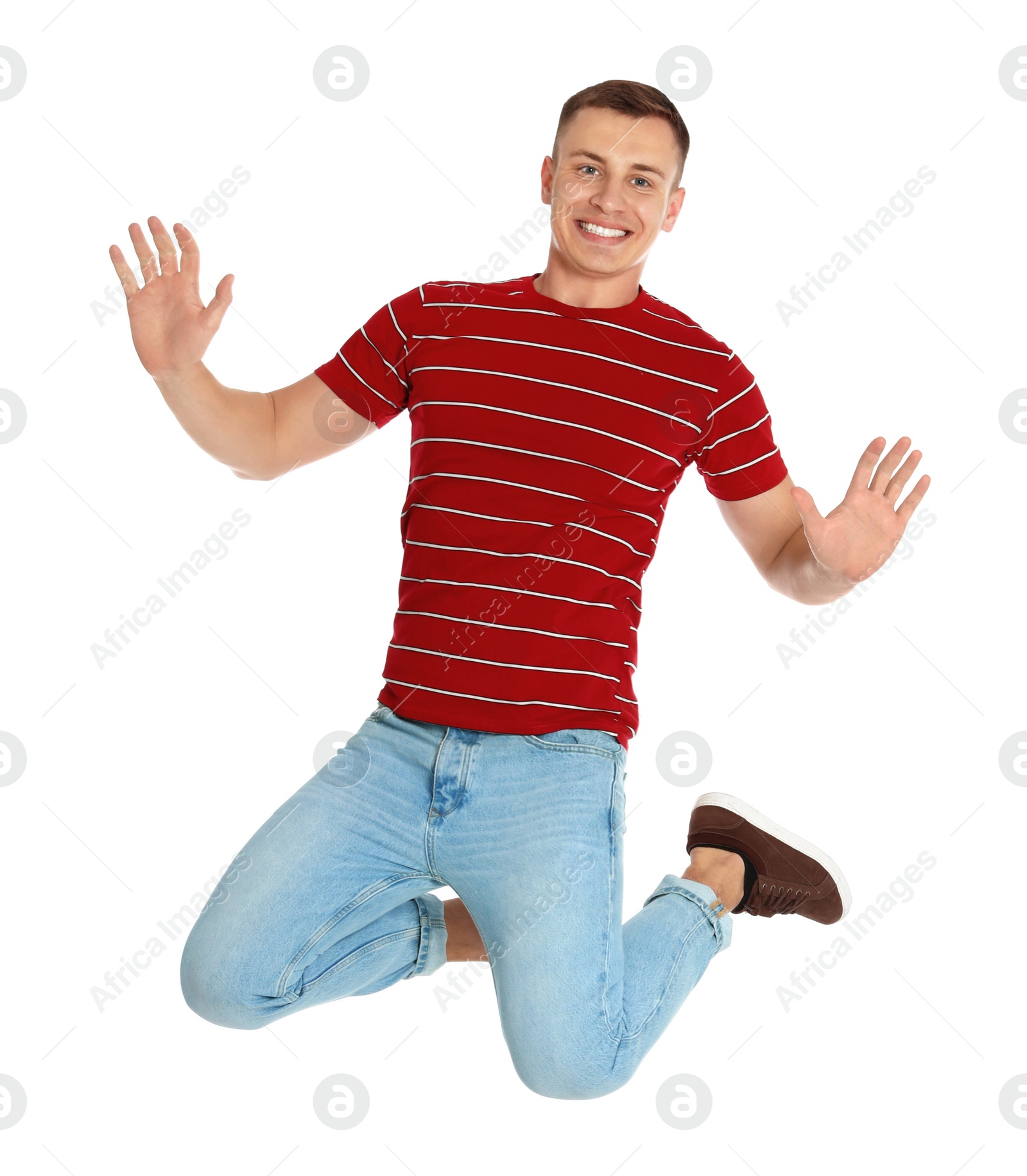 Photo of Happy young man jumping on white background