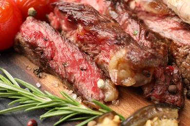Delicious grilled beef steak with spices on table, closeup